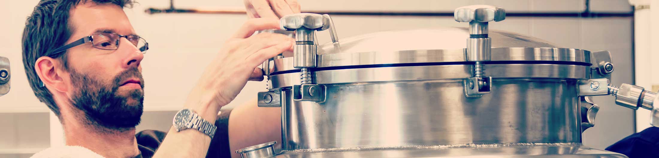Brewery staff checks beer