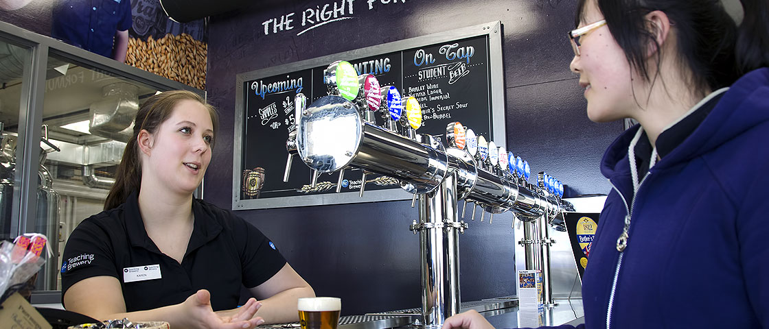 A visitor tastes beer